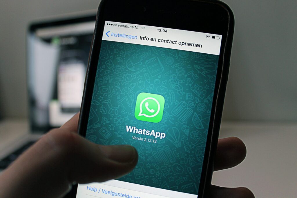The image appears to show a phone with the WhatsApp app open. Would you like assistance with anything specific related to this image, such as creating captions or analyzing its content?